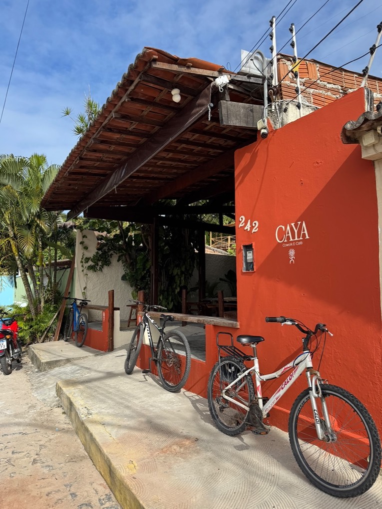 The terracotta CAYA storefront at Largo Sao Sebastiao 242, bikes parked outside